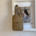 Detail of khaki quilted tote bag featuring a front flap pocket and ribbed texture - Khaki