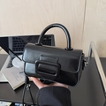 Detail of black glossy leather handbag with oversized buckle and top handle - With Pendant / Black