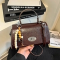 Dark brown retro crossbody bag with glossy crackle texture and beaded wooden pendant - Brown