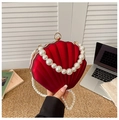 Detail of red shell evening bag featuring large pearl handle and elegant gold clasp - Style 2 Red