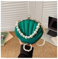 Detail view of emerald green shell-shaped evening bag with pearl chain and gold metal ring - Style 2 Green