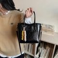 Chic black patent leather bucket bag with colorful beaded charm and adjustable strap - Black