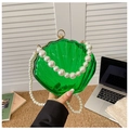 Close-up of green acrylic shell-shaped clutch bag featuring a luxurious pearl strap - Style 1 Green