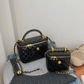 Close-up of black quilted mini chain bags with golden camellia and leather strap - Large / Black