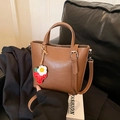 Brown leather bucket bag with strawberry charm and adjustable shoulder strap for women - Brown with Pendant