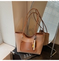 Dettaglio borsa tote marrone vintage con tasca a contrasto e ciondolo di perline colorate - Cachi