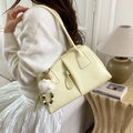 Minimalist light yellow leather underarm bag with decorative knot and gnome charm - With Charm / Yellow