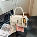 Creamy beige crossbody box bag with wooden bead charm and structured top handle - White