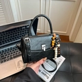 Black vegan leather crossbody bag with wooden bead charm and silver turn-lock closure - Black