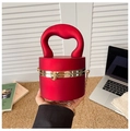 Detail of red cylindrical acrylic bag featuring matte finish and gold ball clasp - Matte Red