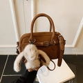 Brown lychee leather crossbody bag with a white bunny plush charm and silver buckle - Brown with Pendant