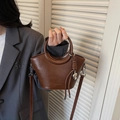 Brown leather bucket bag with round handle and adjustable shoulder strap for women - Brown