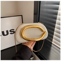 Close-up of beige woven clutch with iconic gold round handle and fine metal chain - White