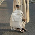 Off-white lychee leather backpack with geometric straps and a brown plush ball charm - With Pendant / White
