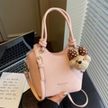 Pink lychee texture bucket bag with knot handles, adjustable strap and cute bear charm - Pink with Pendant