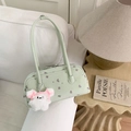 Detail of mint green floral shoulder bag with plush bunny charm on white sofa - With Charm / Green