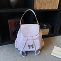 Versatile light purple backpack with silver bow buckle and adjustable straps in home setting - Purple