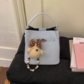 Light blue bucket bag with metal twist lock and cute plush puppy charm accessory - With Charm / Blue