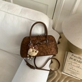 Retro dark brown crossbody bag with matte finish and cute bear pendant on sofa - Brown with Pendant