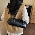 Minimalist black leather Boston bag for women with gold branding and long shoulder strap - Black