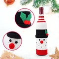 Close-up of a festive snowman knitted wine bottle cover with 3D red nose and belt detail - Snowman