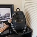 Black pebbled faux leather backpack with wide geometric strap and brown plush charm - With Charm / Black