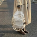 Chic cream white lychee leather backpack with wide woven straps and pompom charm - With Charm / Off-white