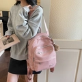 Pink lychee texture faux leather backpack with plush charm and wide straps - With Charm / Pink