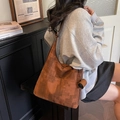 Brown vintage geometric texture large capacity tote bag worn by a model in casual style - Brown