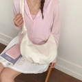 Chic cream white pleated hobo bag for women worn by a model in a casual setting - White