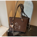 Detail of dark brown suede tote bag with horse embroidery and a horse-shaped charm - Coffee with Pendant