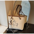 Detail of minimalist pony embroidery and wooden horse charm on the beige tote bag - Cream White With Pendant