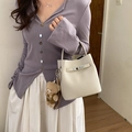 Off-white lychee grain bucket bag with silver lock and a brown plush bear charm - With Charm / White