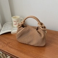 Detailed view of beige bucket bag with pleated texture and golden metal ring accents - Khaki