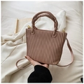 Close-up of Morandi pink pleated bucket bag with dual handles and gold-tone metal hardware - Pink