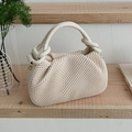 Chic cream white pleated bucket bag with twisted handle and gold hardware detail - Off White