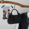 Black pleated bucket bag with a stylish woven texture and a rounded single handle - Black