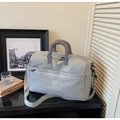 Close-up of gray waterproof travel bag with reinforced handles and NINGJIA logo - Gray