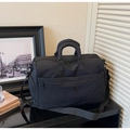 Close-up of black travel bag with reinforced handles and NINGJIA embossed logo detail - Black