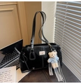 Close-up of black tote bag with white stitching and a cute blue bear plush charm - With Charm / Black