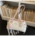 Detail of a vintage-style cream and pink PU leather shoulder bag with a teddy bear charm - With Charm / Pink