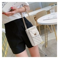 Stylish white quilted crossbody bag with gold chain strap for women in cafe setting - White