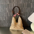 Beige hollow woven straw tote bag with round brown handle and wooden bead accents - Off White