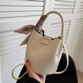 Elegant beige bucket bag in lychee texture leather with a decorative floral twilly scarf - White