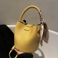 Yellow litchi grain bucket bag with silk scarf handle and detachable strap - Yellow