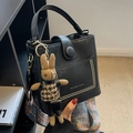 Black bucket bag with patterned strap and cute rabbit charm in a modern minimalist style - With Ornament / Black