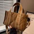 Brown quilted nylon tote bag with wide adjustable shoulder strap and wave pattern - Brown