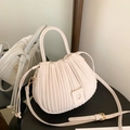 Elegant beige pleated bucket bag with top handle and crossbody strap in cream finish - Off White