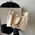 Minimalist off-white canvas tote bag with khaki straps and front pocket detail - Off-white