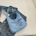 Light blue canvas tote bag with black typography and wide shoulder strap style - Blue